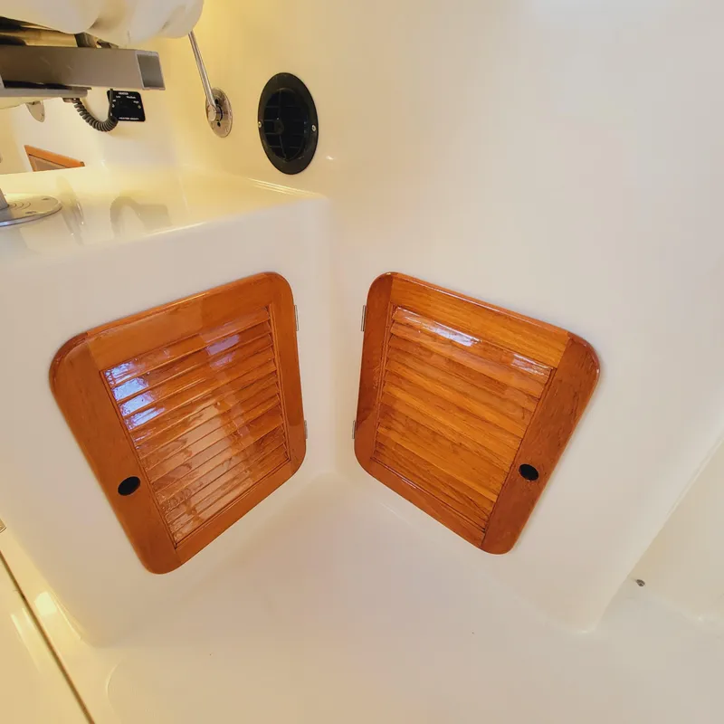 Slide: The Image of 1999 Hinckley Picnic Boat Classic interior with wooden vented panels. - 12