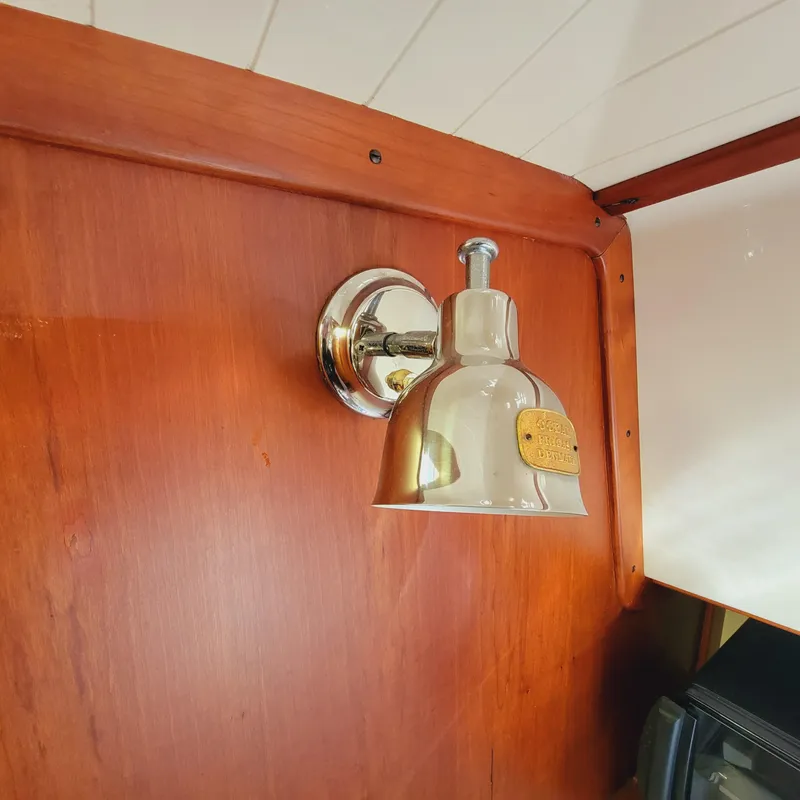 Slide: The Image of Chrome wall light fixture on 1999 Hinckley Picnic Boat Classic wooden interior. - 18