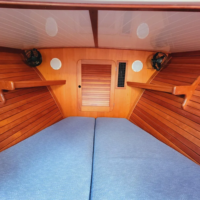 Slide: The Image of Interior of a 1999 Hinckley Picnic Boat Classic with wooden paneling and blue cushions. - 20