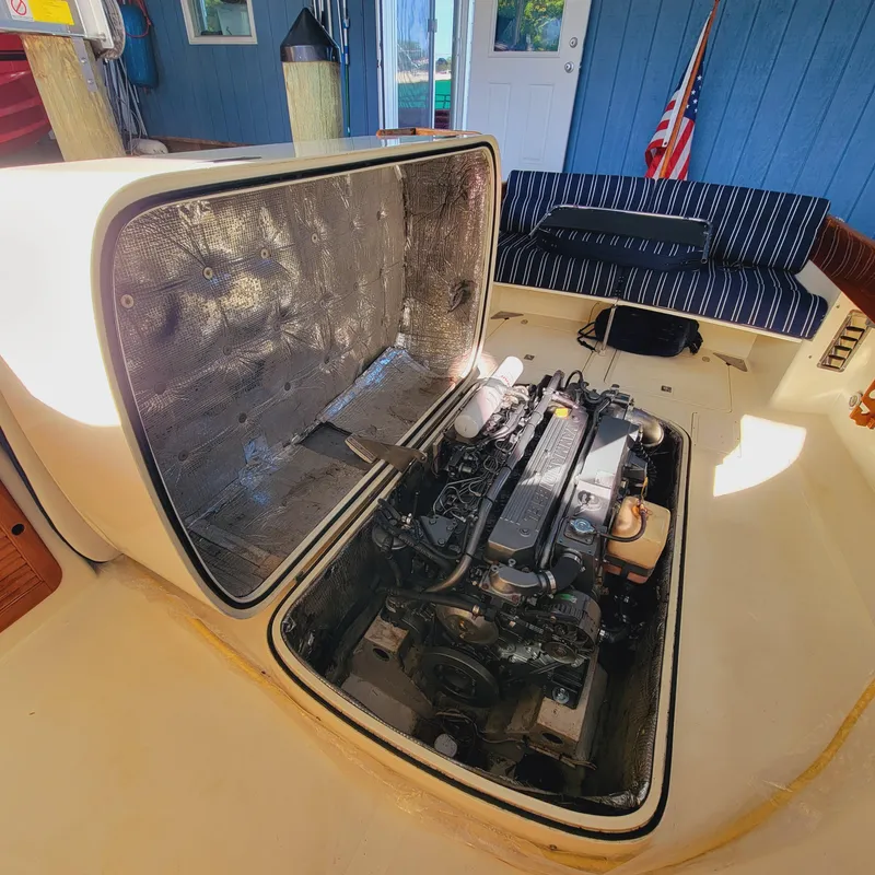 Slide: The Image of 1999 Hinckley Picnic Boat Classic engine compartment with open hatch, showcasing interior details. - 25