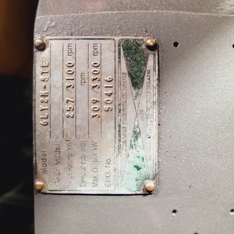 Slide: The Image of Close-up of a metal engine plate on a 1999 Hinckley Picnic Boat Classic. - 27