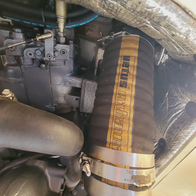 Slide: The Image of Engine compartment of a 1999 Hinckley Picnic Boat Classic, featuring exhaust components. - 32