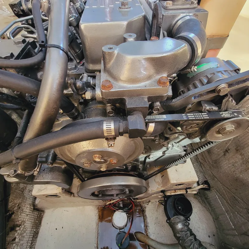 Slide: The Image of Engine of a 1999 Hinckley Picnic Boat Classic, showcasing mechanical components and belts. - 33