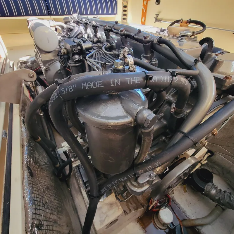 Slide: The Image of Engine of a 1999 Hinckley Picnic Boat Classic with visible hoses and components. - 34