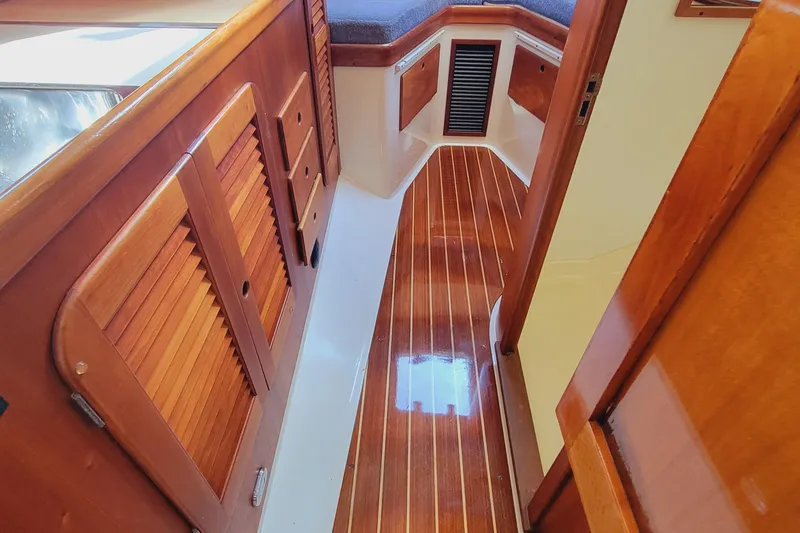 Slide: The Image of 1999 Hinckley Picnic Boat Classic interior with polished wood flooring and cabinetry. - 38