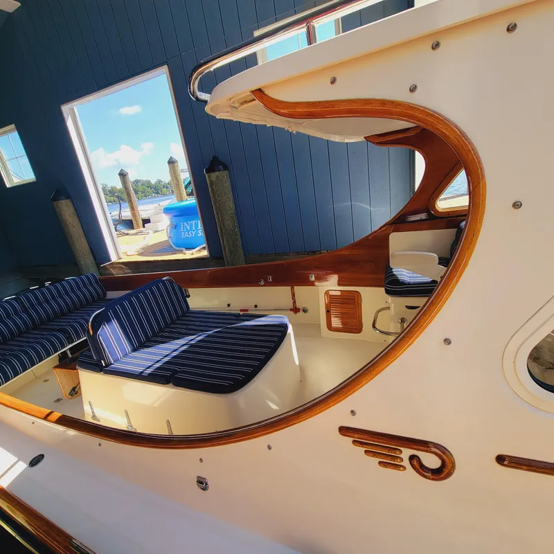 Slide: The Image of 1999 Hinckley Picnic Boat Classic interior with striped seating and elegant woodwork. - 43