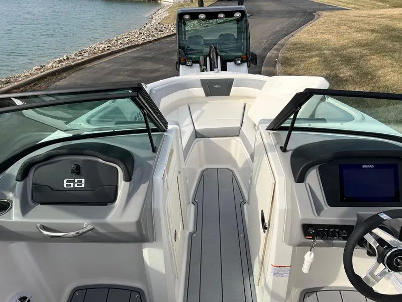 Slide: The Image of 2025 Chaparral 21 SSi boat interior with modern dashboard and steering wheel. - 10