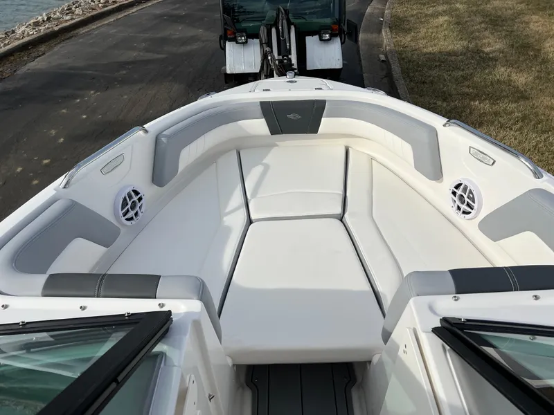 Slide: The Image of 2025 Chaparral 21 SSi boat interior with white seating and speakers. - 12