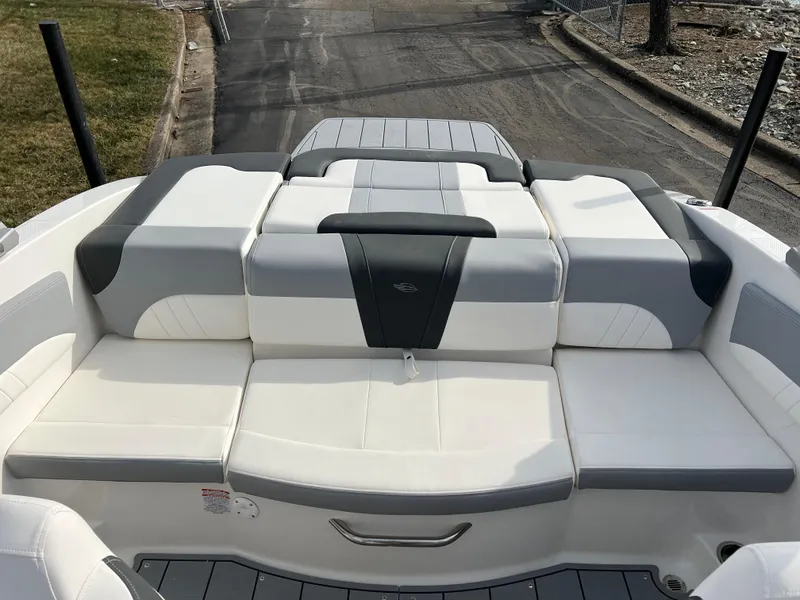 Slide: The Image of 2025 Chaparral 21 SSi boat with spacious, cushioned seating in white and gray. - 16