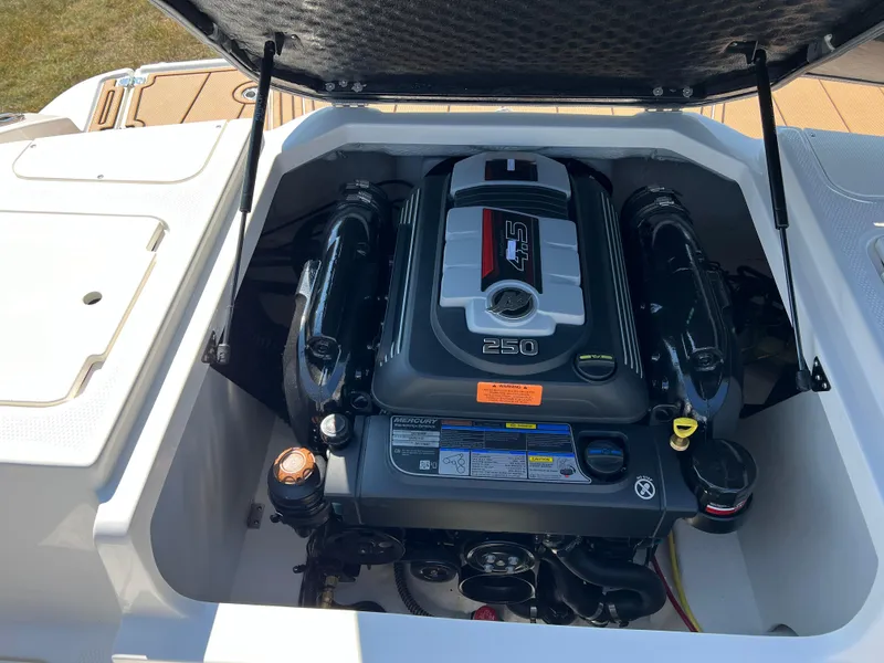 Slide: The Image of 2025 Chaparral 21 SSi boat engine compartment with open hatch, showcasing powerful engine. - 17
