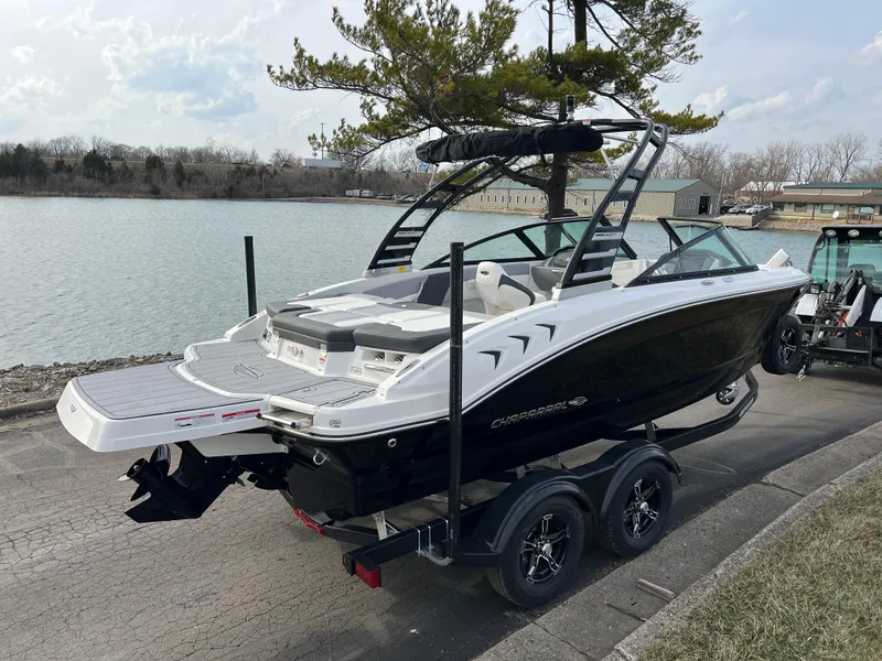 Slide: The Image of 2025 Chaparral 21 SSi boat on trailer by a lake, ready for adventure. - 3