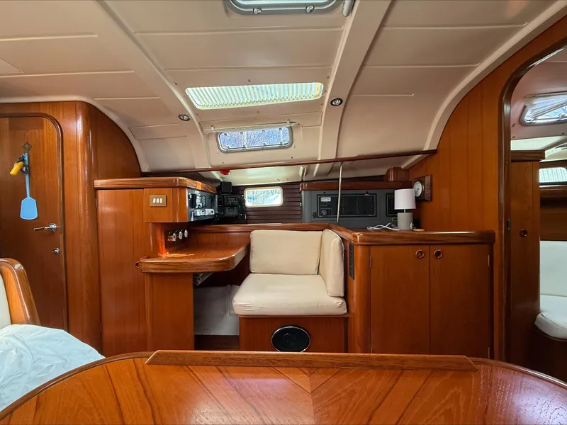 Slide: The Image of Interior of 1993 Beneteau Oceanis 400 sailboat with wooden furnishings and seating area. - 13