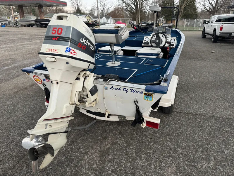 Slide: The Image of 1994 Lowe 170 boat with Johnson 50 HP outboard motor on a trailer. - 3