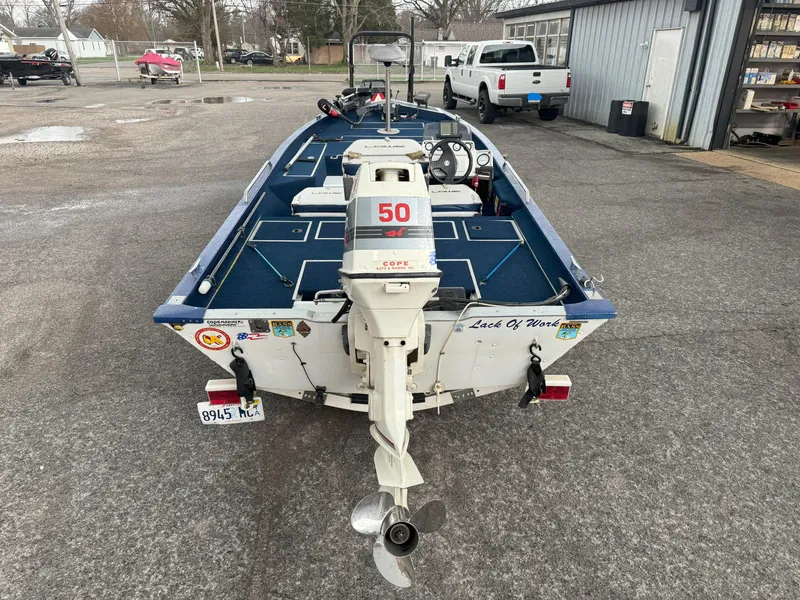 Slide: The Image of 1994 Lowe 170 boat with outboard motor, parked in a lot, rear view. - 5