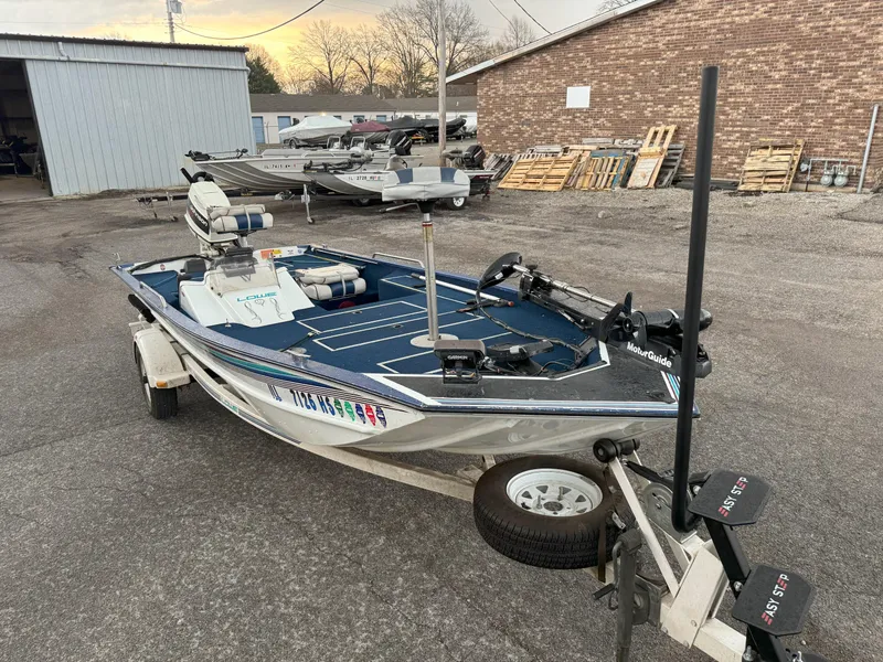 Slide: The Image of 1994 Lowe 170 boat on trailer in outdoor storage area. - 6