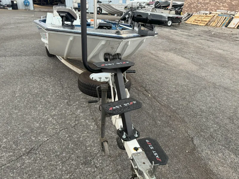 Slide: The Image of 1994 Lowe 170 boat with Easy Step trailer on asphalt, featuring a sturdy metal frame. - 7