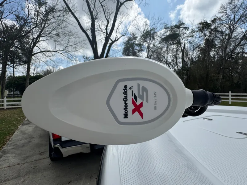 Slide: The Image of MotorGuide X5 trolling motor on 2011 BlackJack 224 boat, parked outdoors. - 14