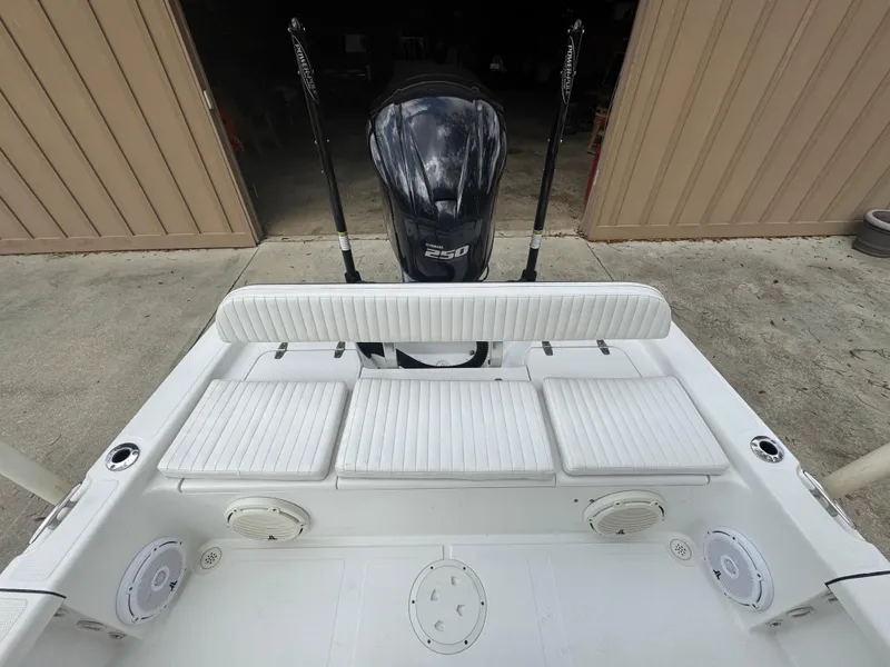 Slide: The Image of 2011 BlackJack 224 boat with seating and outboard motor in a garage setting. - 18