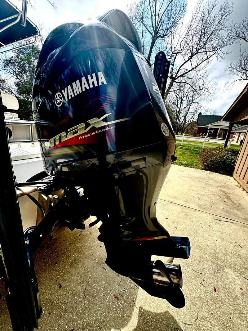 Slide: The Image of Yamaha outboard motor on BlackJack 224 boat, 2011 model, parked outdoors. - 28