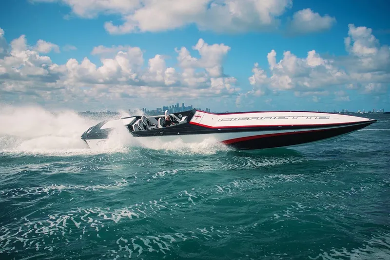 The Image of 2013 Cigarette 50' Marauder speedboat racing on open water under a clear sky. - 0