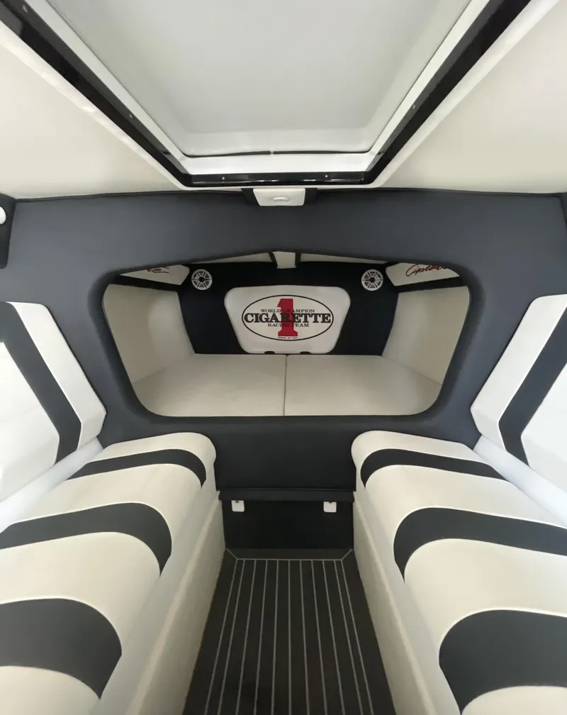 Slide: The Image of Interior of 2013 Cigarette 50' Marauder boat with striped seating and logo. - 5