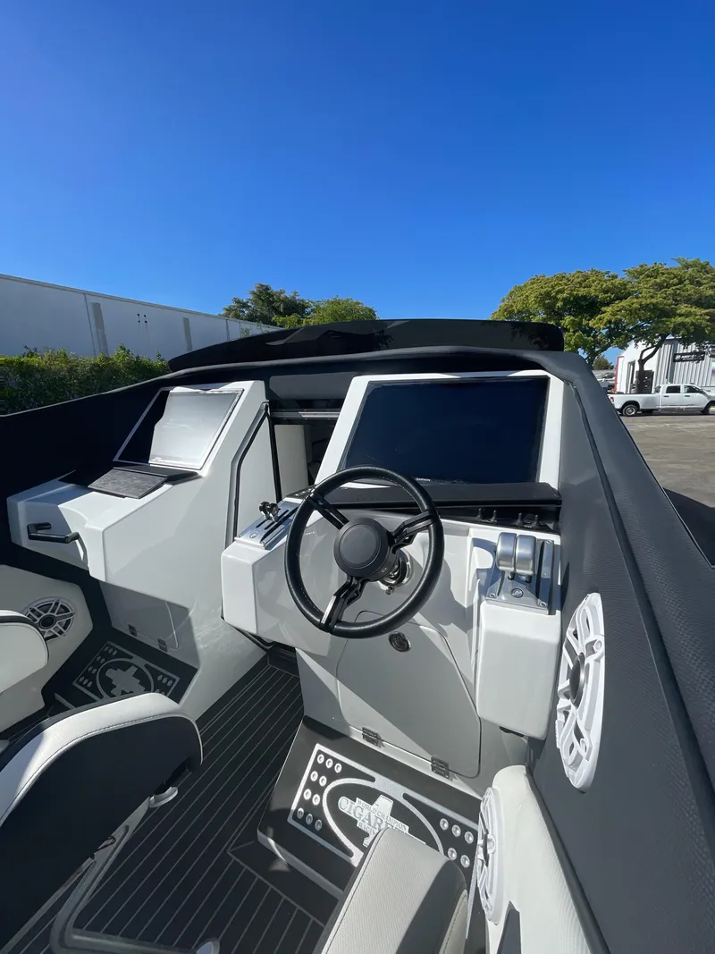 Slide: The Image of Cockpit of 2013 Cigarette 50' Marauder boat with modern controls and steering wheel. - 7
