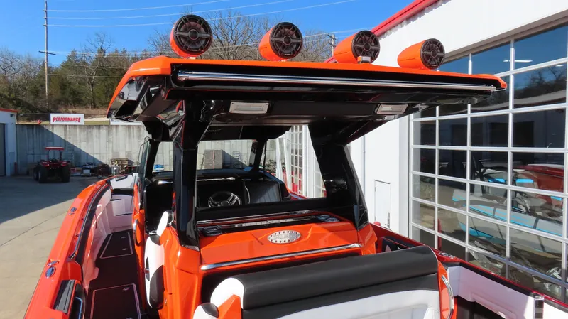 Slide: The Image of 2023 Nor-Tech 450 boat with vibrant orange detailing and advanced audio system. - 12