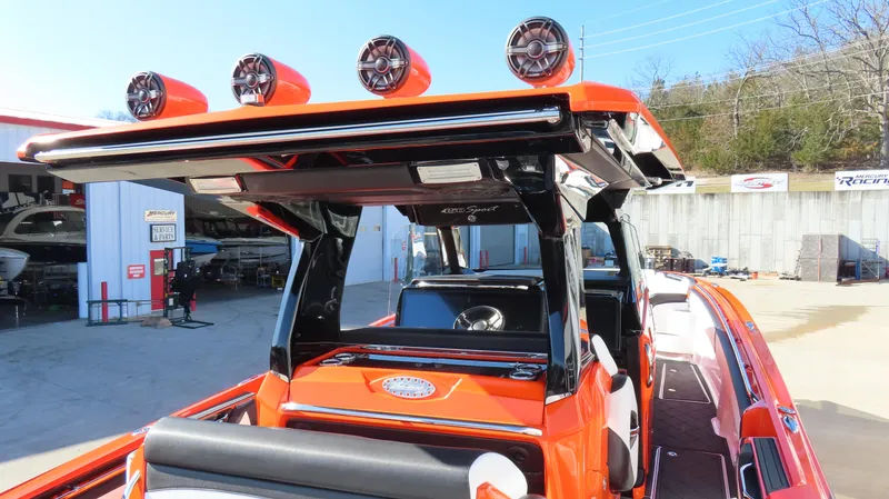 Slide: The Image of 2023 Nor-Tech 450 boat with vibrant orange exterior and advanced audio system. - 13