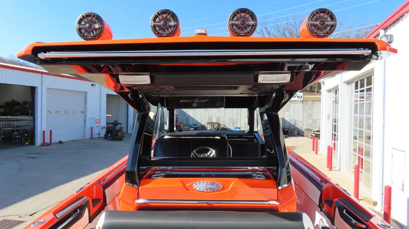 Slide: The Image of 2023 Nor-Tech 450 boat with vibrant orange exterior and advanced audio system. - 15