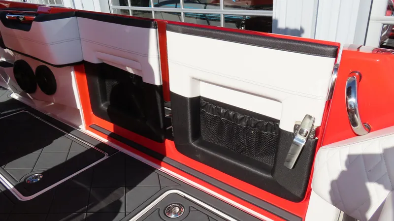 Slide: The Image of Interior of 2023 Nor-Tech 450 boat with red, black, and white seating and storage compartments. - 16