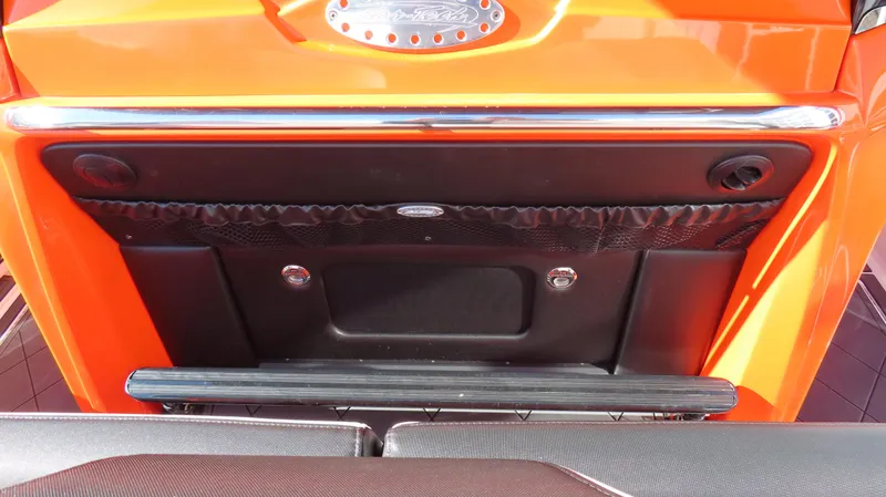 Slide: The Image of 2023 Nor-Tech 450 boat, orange exterior, rear view with storage compartment and chrome accents. - 19