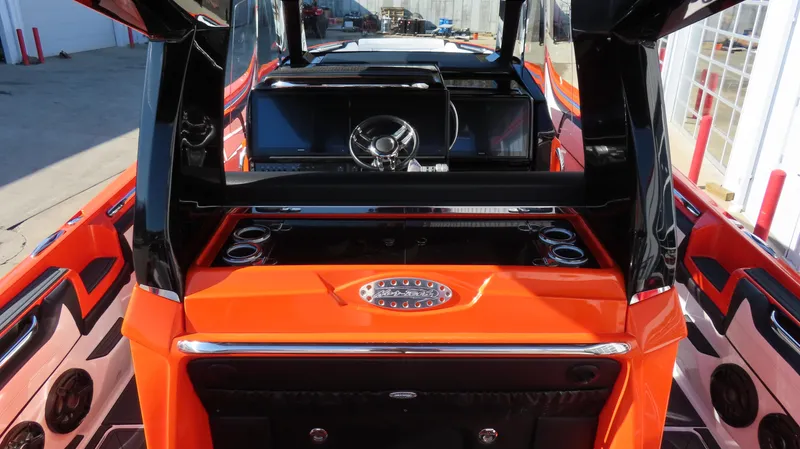 Slide: The Image of 2023 Nor-Tech 450 boat interior with vibrant orange accents and modern dashboard design. - 22