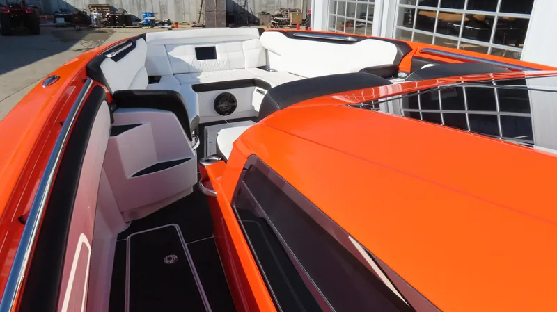 Slide: The Image of 2023 Nor-Tech 450 boat with vibrant orange exterior and luxurious white seating. - 24