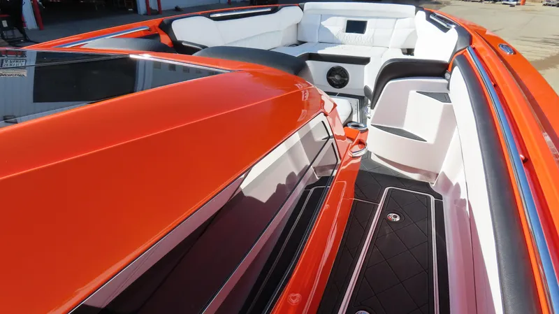 Slide: The Image of 2023 Nor-Tech 450 boat interior with sleek orange and white design, luxurious seating. - 25