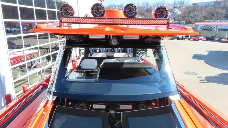 Slide: The Image of 2023 Nor-Tech 450 boat with vibrant orange exterior and advanced lighting system. - 27