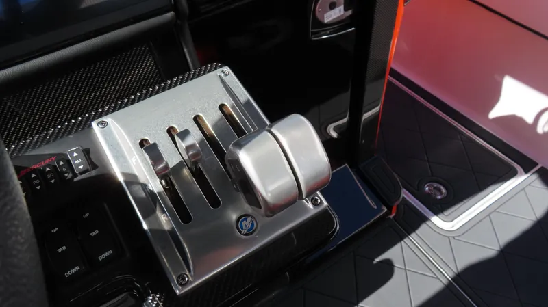 Slide: The Image of Throttle controls of a 2023 Nor-Tech 450 boat, featuring sleek metallic design. - 28