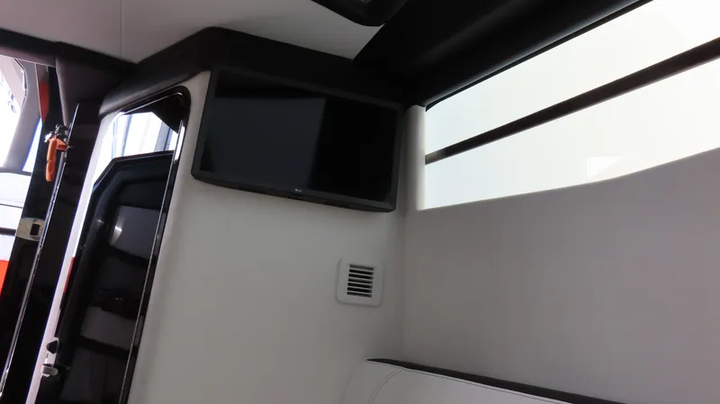 Slide: The Image of Interior of 2023 Nor-Tech 450 boat featuring a mounted TV and sleek design. - 32