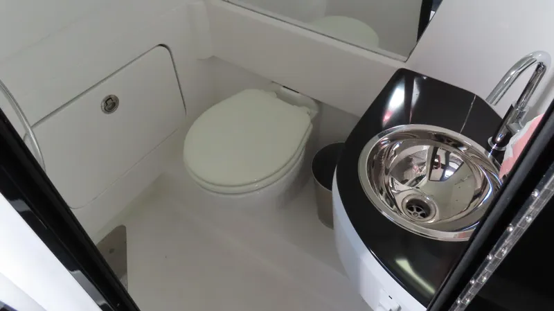 Slide: The Image of Modern bathroom in 2023 Nor-Tech 450 boat with toilet and sleek sink. - 34
