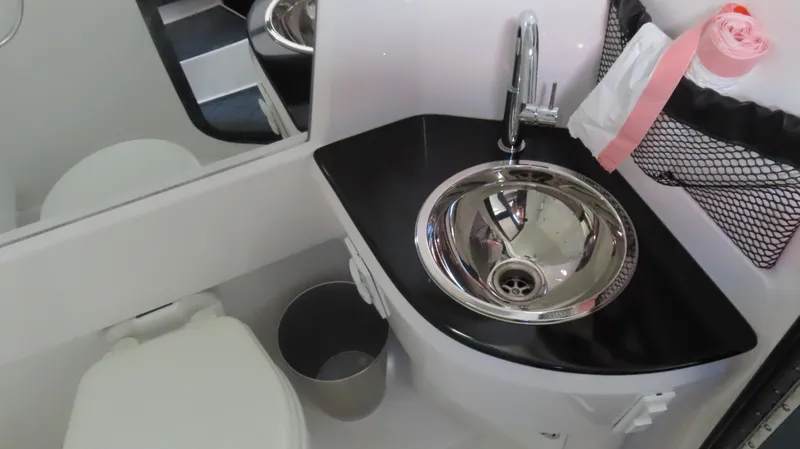 Slide: The Image of 2023 Nor-Tech 450 boat bathroom with modern sink, faucet, and toilet. - 35