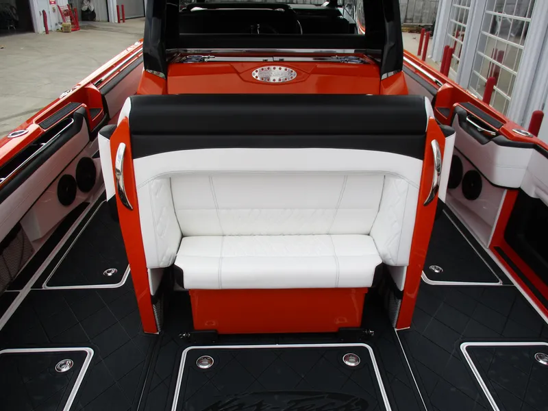 Slide: The Image of 2023 Nor-Tech 450 boat interior with red and black accents, featuring white seating. - 38
