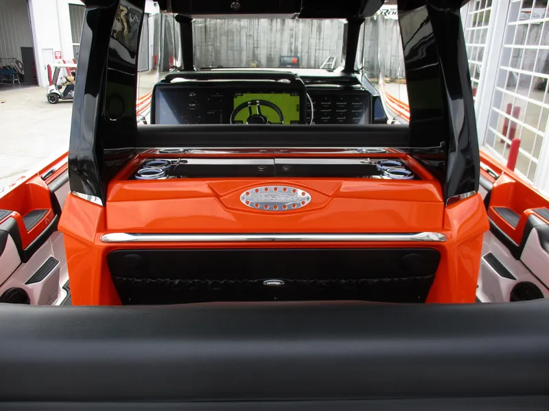 Slide: The Image of 2023 Nor-Tech 450 boat interior with vibrant orange accents and modern dashboard. - 39