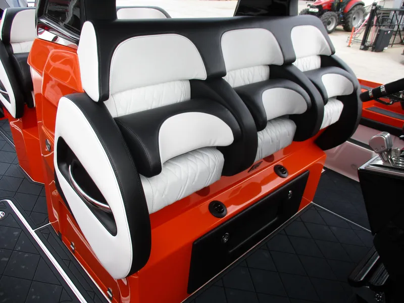 Slide: The Image of 2023 Nor-Tech 450 boat interior with stylish black and white seating on orange base. - 41