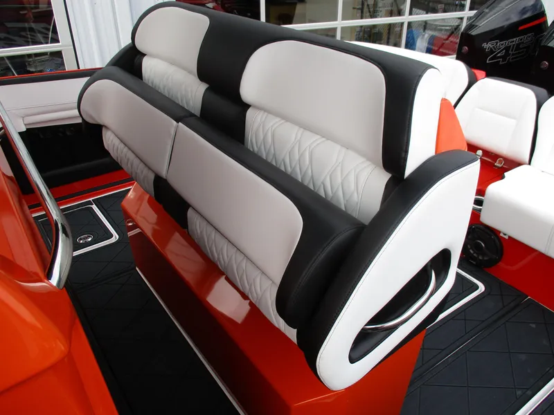 Slide: The Image of 2023 Nor-Tech 450 boat seating with black and white upholstery, orange accents. - 45