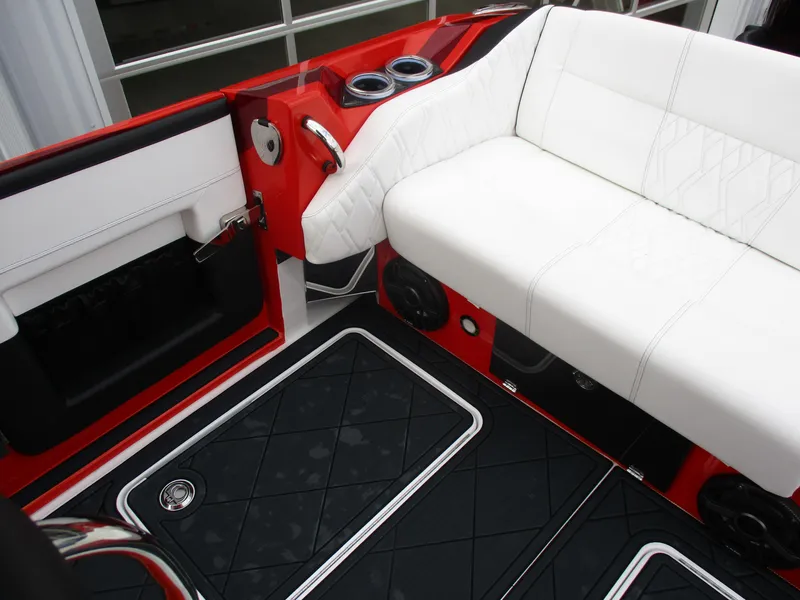 Slide: The Image of 2023 Nor-Tech 450 boat interior with white seating, red accents, and black flooring. - 47