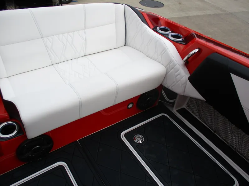 Slide: The Image of 2023 Nor-Tech 450 boat interior with white seating, red accents, and cup holders. - 49