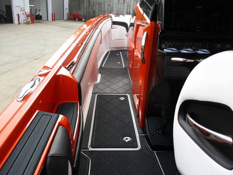 Slide: The Image of 2023 Nor-Tech 450 boat interior with orange accents and sleek black flooring. - 51