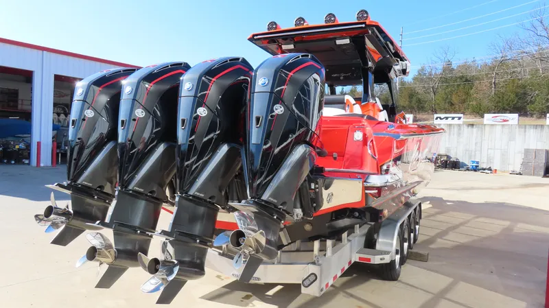 Slide: The Image of 2023 Nor-Tech 450 boat with four powerful outboard engines on a trailer. - 6