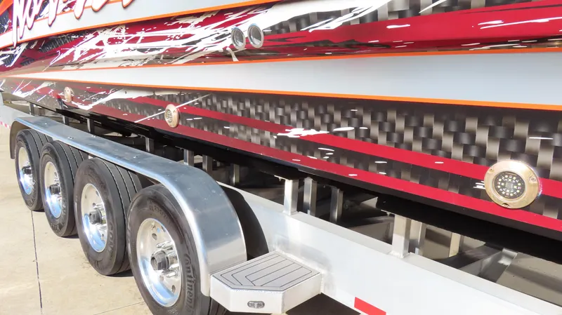 Slide: The Image of 2023 Nor-Tech 450 boat on trailer, showcasing sleek design and vibrant graphics. - 8