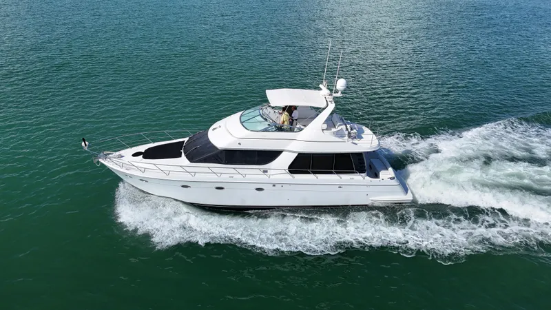 The Image of 1999 Carver 530 Voyager Pilothouse yacht cruising on open water. - 0