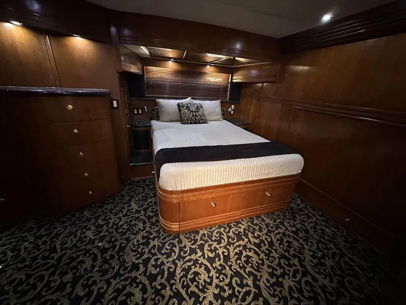 Slide: The Image of Luxurious bedroom interior of 1999 Carver 530 Voyager Pilothouse yacht with elegant wood finish. - 22